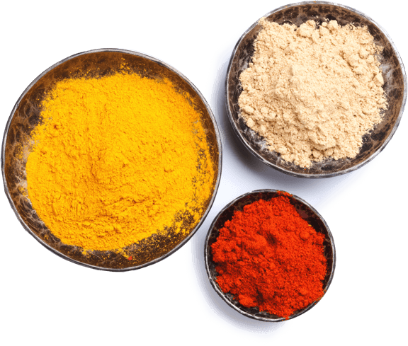 A photo of three dieshes with freshly ground turmeric, ginger and cayenne.